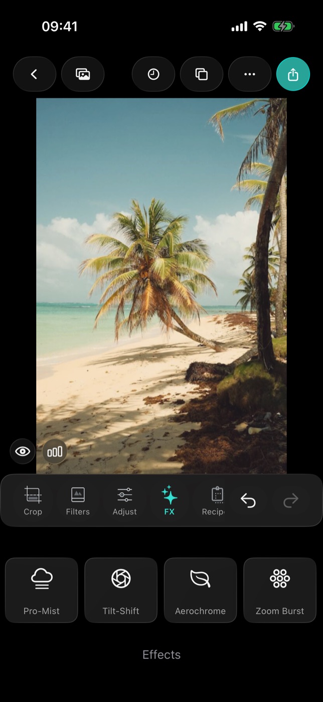The FX tab in the Filmode editor on a beach photo, showing the Pro-Mist, Tilt-Shift, Aerochrome and Zoom Burst tiles on the last page of effects.